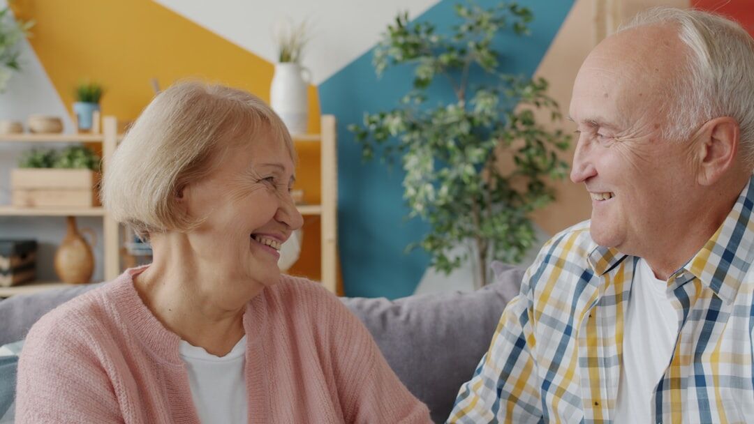 elderly couple exercising at home