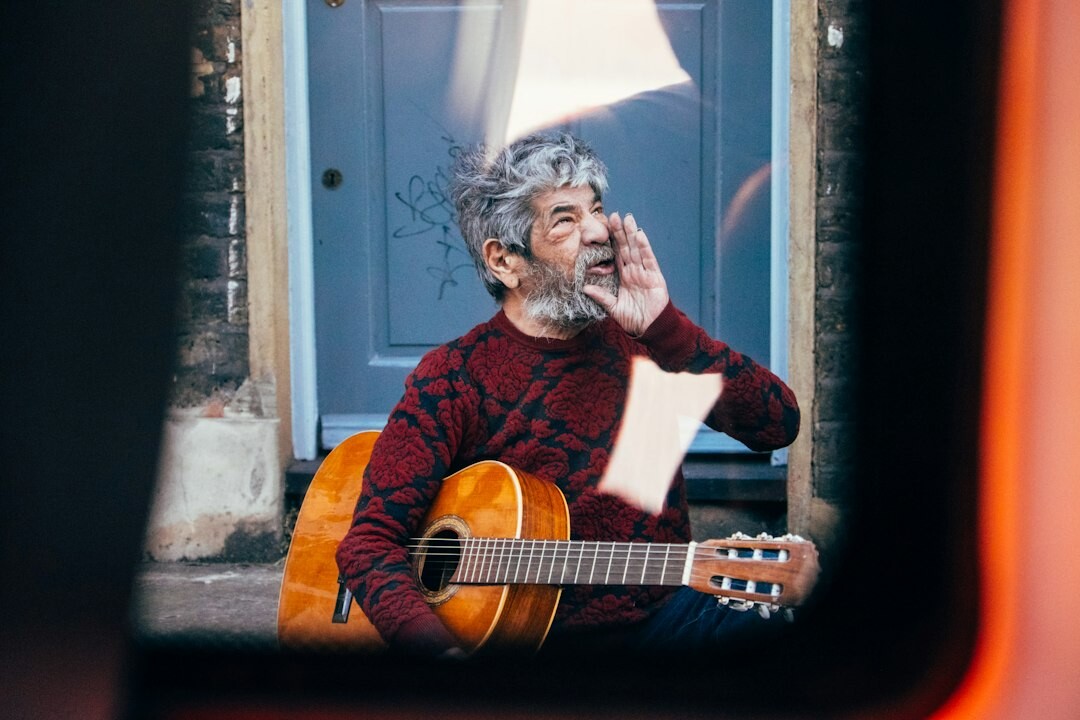 elderly man learning guitar